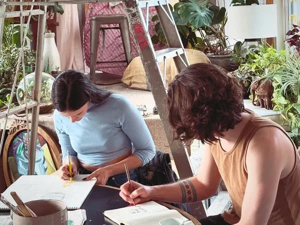 Two people sketching in studio