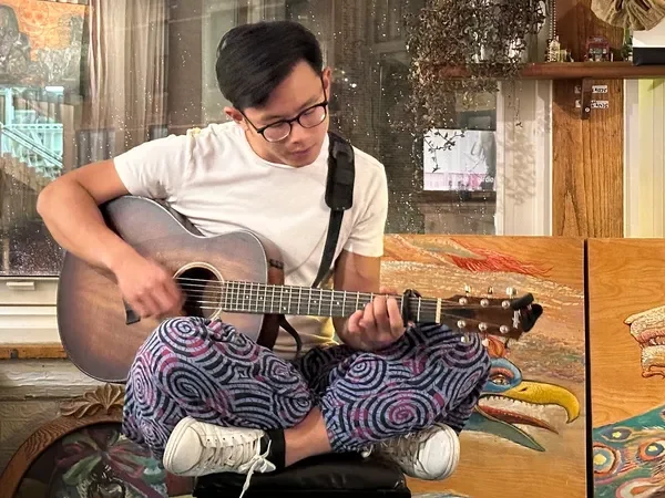 Musician playing guitar in studio